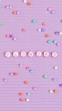 Flowers typography beads alphabet purple background