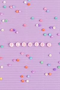 Beads letter flowers typography purple background