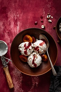 Roasted plums ice cream on red table