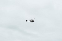 Helicopter flying in a cloudy sky