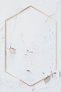 Hexagon gold frame on weathered white paint textured background vector