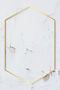 Hexagon gold frame on weathered white paint textured background vector