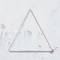Triangle rose gold frame on weathered white wall vector