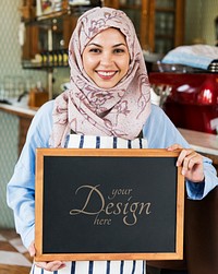 Muslim female entrepreneur holding a blackboard mockup