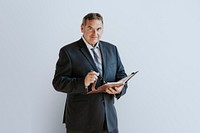 Businessman writing on a book