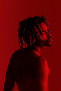 Black man posing by a red background