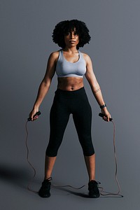 African American woman standing holding skipping rope