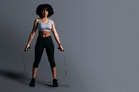 African American woman standing holding skipping rope