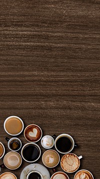 Mixed coffee cups on a walnut wooden textured background