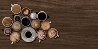 Mixed coffee cups on a walnut wooden textured background