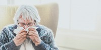 Coronavirus infected senior woman sneezing into a tissue paper social template