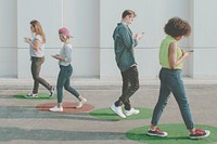 Young adults using smartphones as they are walking outdoors