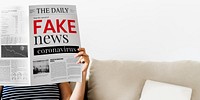 Woman reading fake coronavirus news from a newspaper during coronavirus quarantine