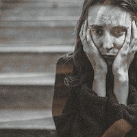 Distressed woman sitting on a staircase thinking deeply social ad