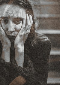 Distressed woman sitting on a staircase thinking deeply
