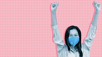 Cheerful Asian woman wearing a mask arms raised in a pink background banner
