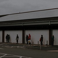 People lining up outside the supermarket social distancing during coronavirus pandemic. MARCH 30, 2020 - BRISTOL, UK