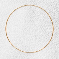 Round gold frame on a white leather textured background