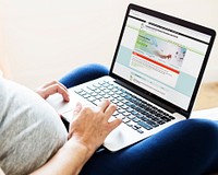 Pregnant woman reading coronavirus information from a laptop mockup with editorial graphic from <a href="https://www.ecdc.europa.eu/en">https://www.ecdc.europa.eu/en</a> accessed on April 8th 2020. BANGKOK, THAILAND - JANUARY 19, 2018