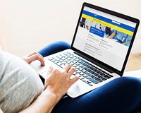 Pregnant woman reading coronavirus updates from a laptop mockup with editorial graphic from <a href="https://www.nhs.uk/" target="_blank">https://www.nhs.uk</a> accessed on April 8th 2020. BANGKOK, THAILAND - JANUARY 17, 2018