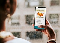 Woman reading coronavirus updates from a mobile phone mockup with editorial graphic from <a href="https://www.cdc.gov/coronavirus/2019-ncov/cases-updates/cases-in-us.html">https://www.cdc.gov/coronavirus/2019-ncov/cases-updates/cases-in-us.html</a> accessed on April 8th 2020. LOS ANGELES, USA- APRIL 9, 2019