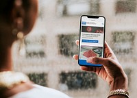 Woman reading coronavirus updates from a mobile phone mockup with editorial graphic from <a href="https://www.cdc.gov/" target="_blank">https://www.cdc.gov</a> accessed on April 8th 2020. LOS ANGELES, USA &ndash;APRIL 9, 2019