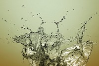 Water splashing on a light golden background design resource 
