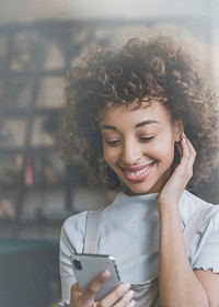 Woman connecting on social media smiling at her phone background