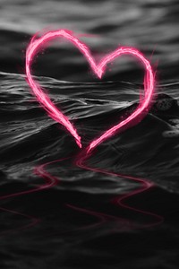 Pink fire heart against the dark sea