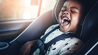 Cheerful kid in a car seat