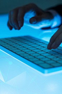 Human hand typing on wireless keyboard