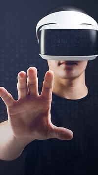 Man with VR headset touching invisible object