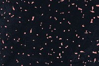 Pink confetti on a black marble textured background