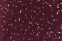 Pink confetti on a maroon marble textured background