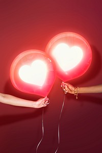 Couple holding love balloons for online dating advertisement