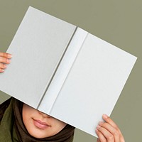 Woman holding white hardcover book with design space