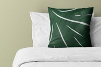 Pillow on bed with green pattern