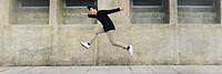 Boy jumping in mid-air on the street