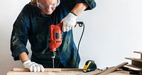 Handyman using a hand drilling machine