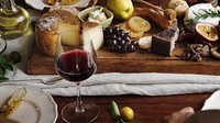 Platter of cheese with seasonal fruits and wine