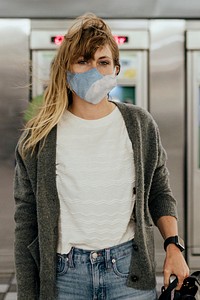 Woman wearing a mask while waiting for the train during the coronavirus pandemic 
