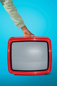 Woman holding an old red television