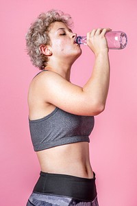 Thirsty young woman in a sportswear