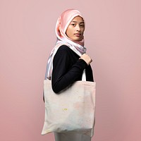 Muslim woman carrying a tote bag