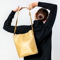 Woman from behind with a yellow cross body bag