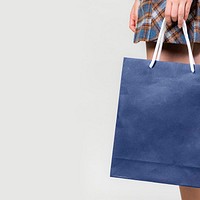 Woman carrying a blue shopping bag