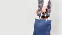 Woman carrying a blue shopping bag