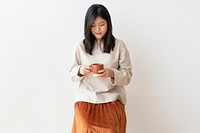 Asian woman with a cup of coffee in her hand