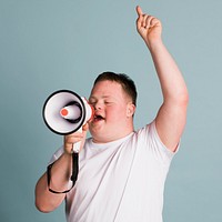 Cute boy with down syndrome using a megaphone to amplify his voice  