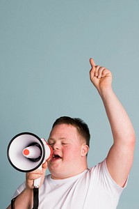 Cute boy with down syndrome using a megaphone to amplify his voice  